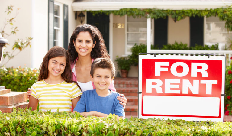 Family in Front on Home next to For Rent sign